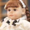 Păpușă Reborn cu Rochie Dantelată și Fundiță Elegantă – 36 cm